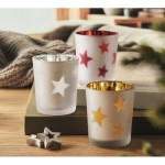 Vela luz LED en frasco de cristal con estrellitas navideñas color rojo vista bodegón