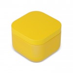 Vela de cera vegetal con aroma a vainilla en tarro de metal cuadrado color amarillo