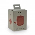 Altavoz Sony SRS-XB100 compacto y potente con larga automomia color naranja vista con caja